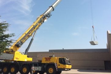 Crane lifts HVAC units to the roof of Ferguson Education Center