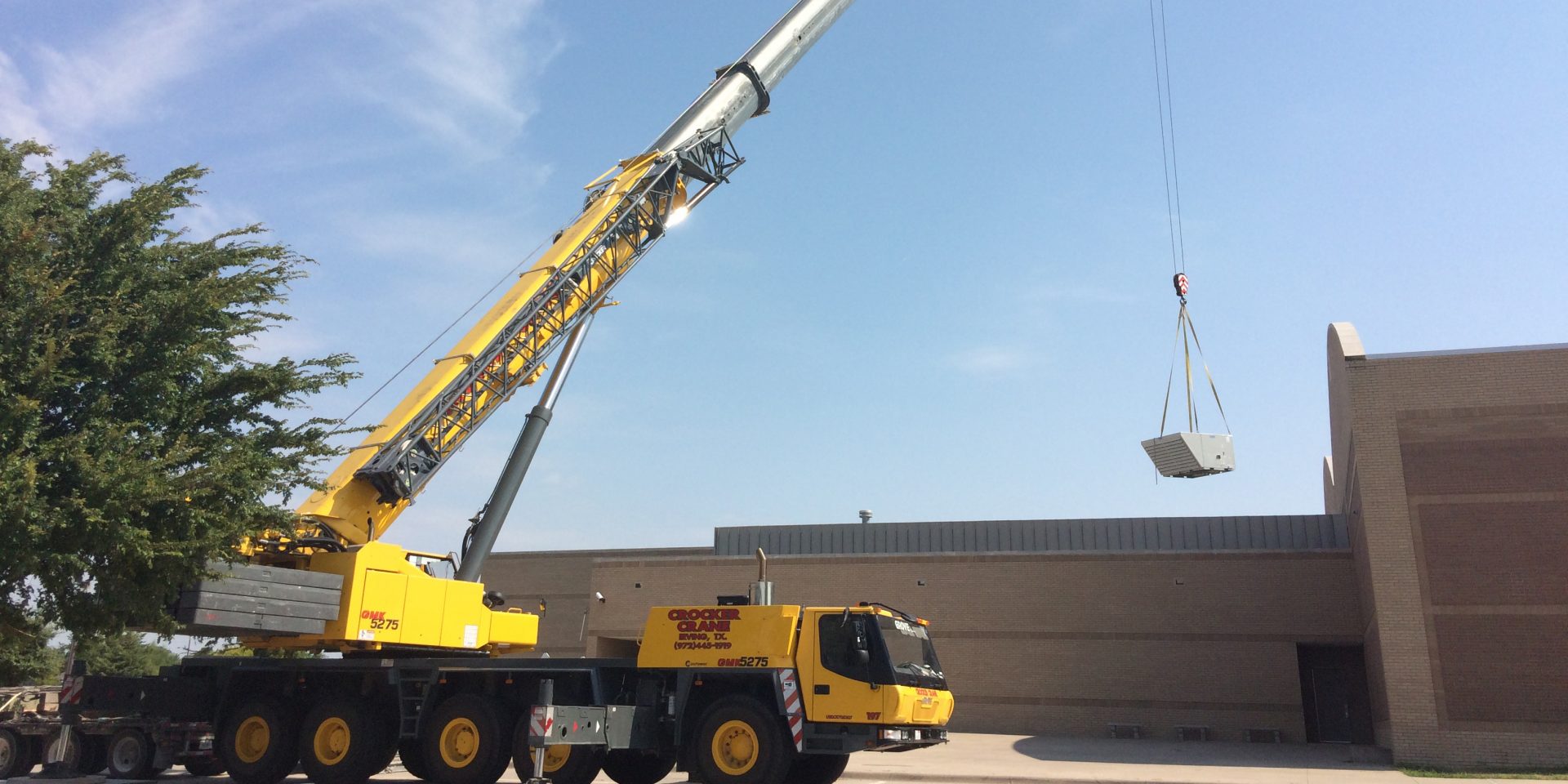 Crane lifts HVAC units to the roof of Ferguson Education Center