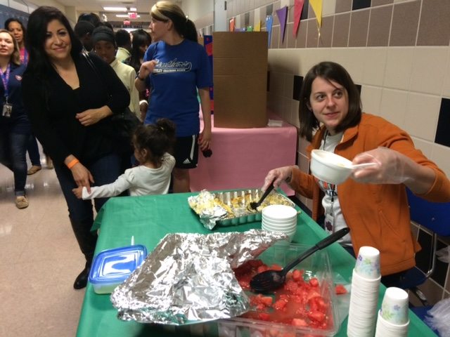 A teacher dishes up food at the Ousley Multi-cultural Festival