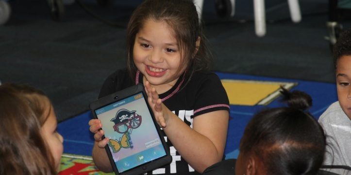 Student uses i-pad in Wood Elementary library