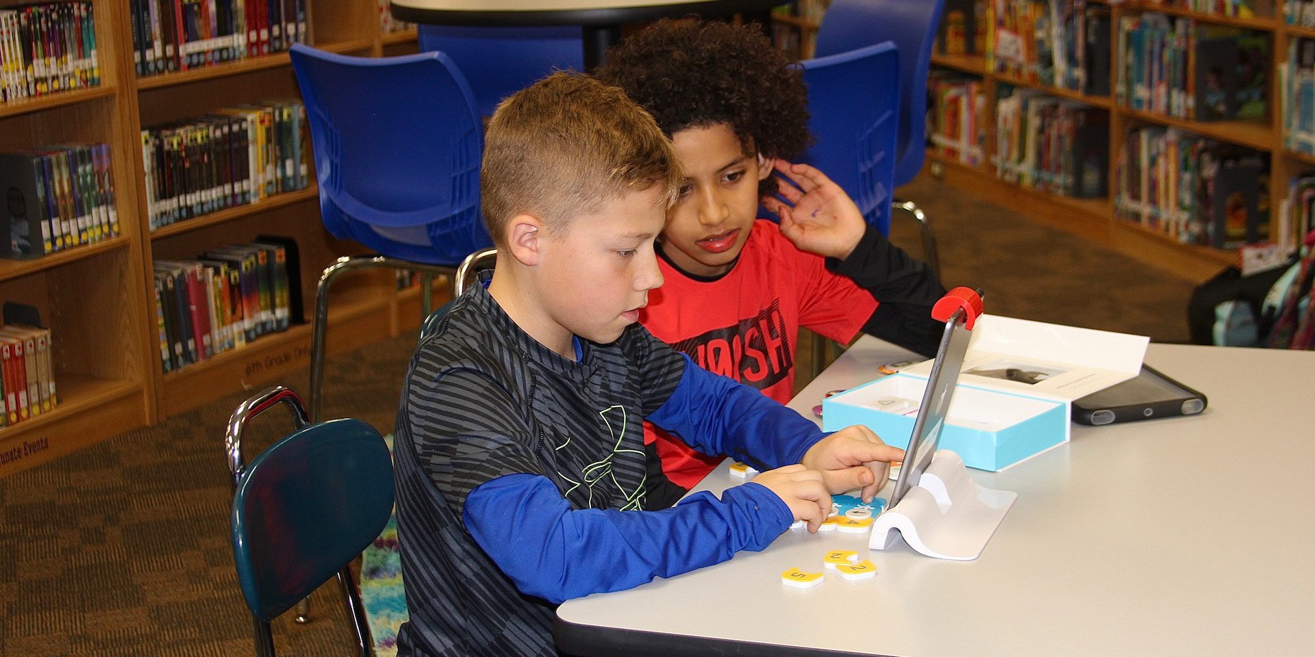Two students use technology in the Butler Elementary library makerspace