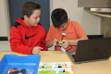 Two students work on coding Lego robots in the Pearcy STEM lab