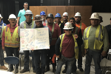 Construction crew that roofed Duff Elementary pose after a pizza party