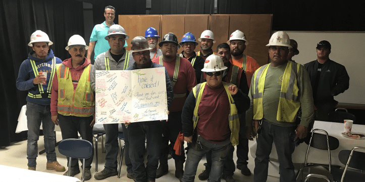 Construction crew that roofed Duff Elementary pose after a pizza party