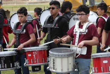 Workman Junior High's drumline performs at the ceremony announcing a new track and field for Workman