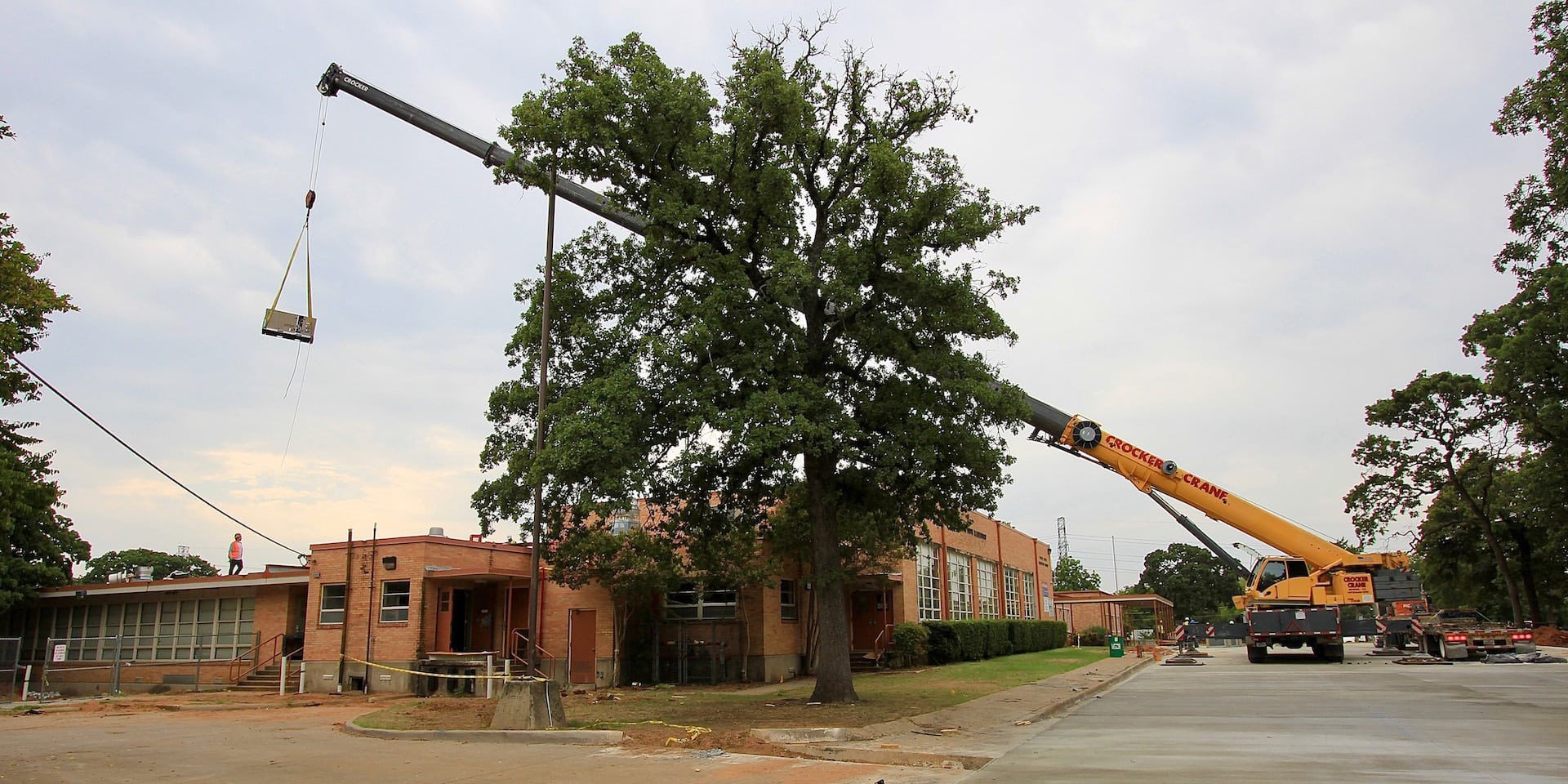 Crane "flys" new RTU to the roof of South Davis Elementary