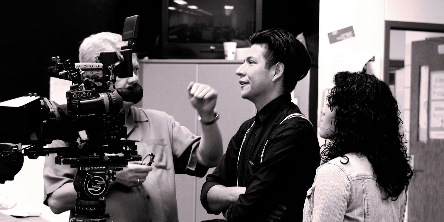 Students with video camera planning a production