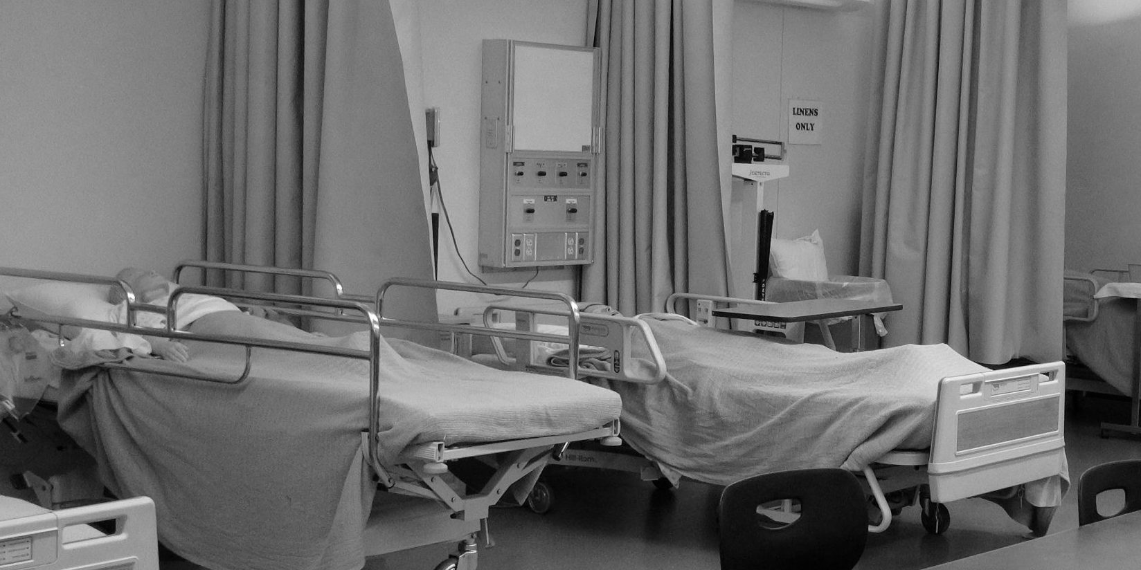 Picture of empty hospital beds within a classroom.