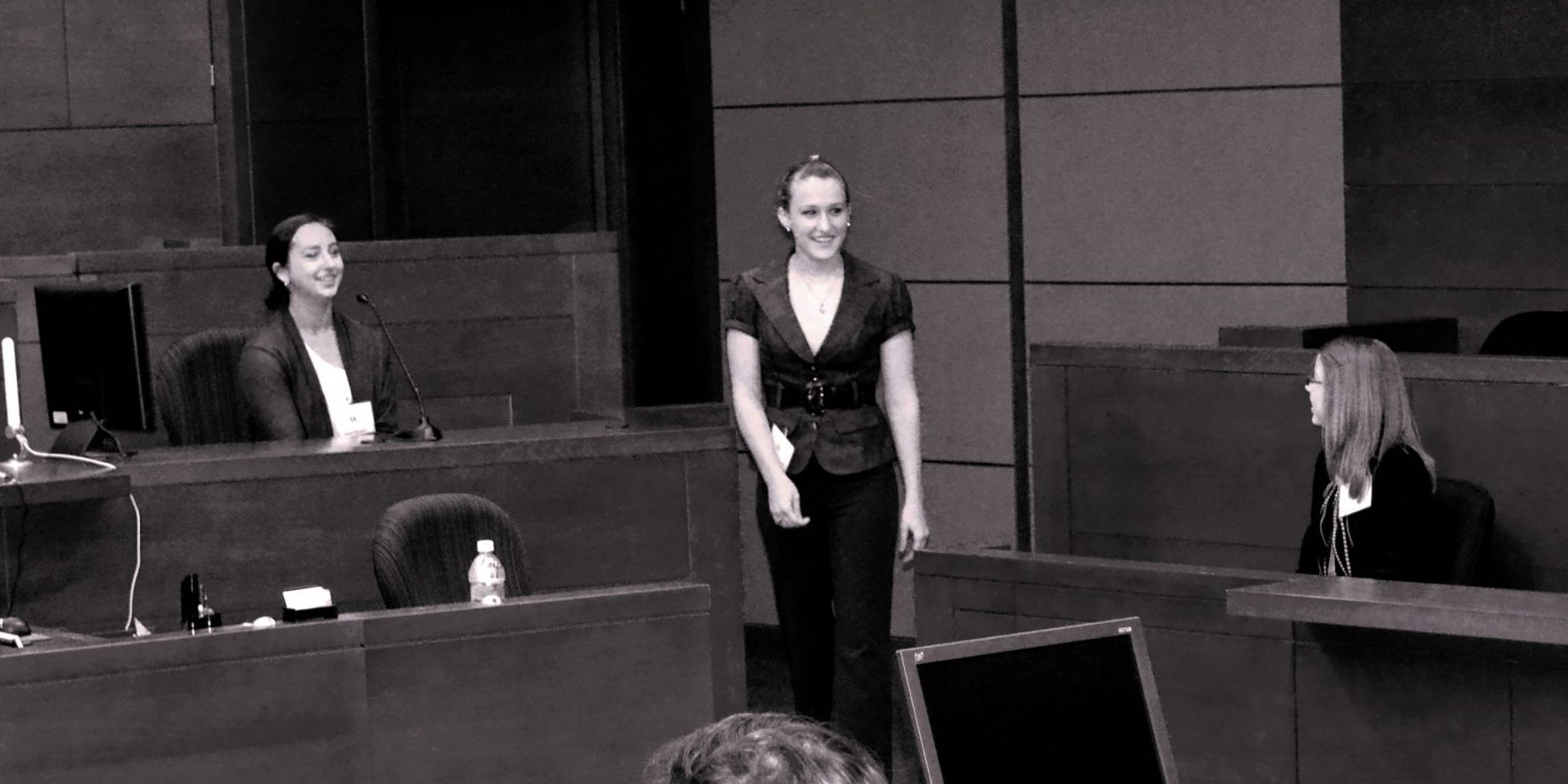 Students practicing in a mock-courtroom.