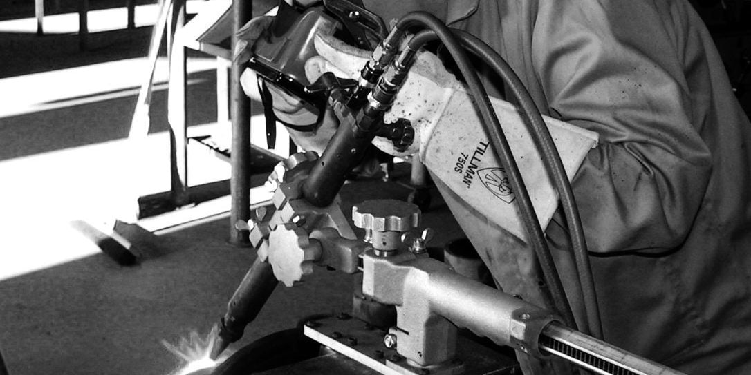 picture showing instructor inspecting a weld.