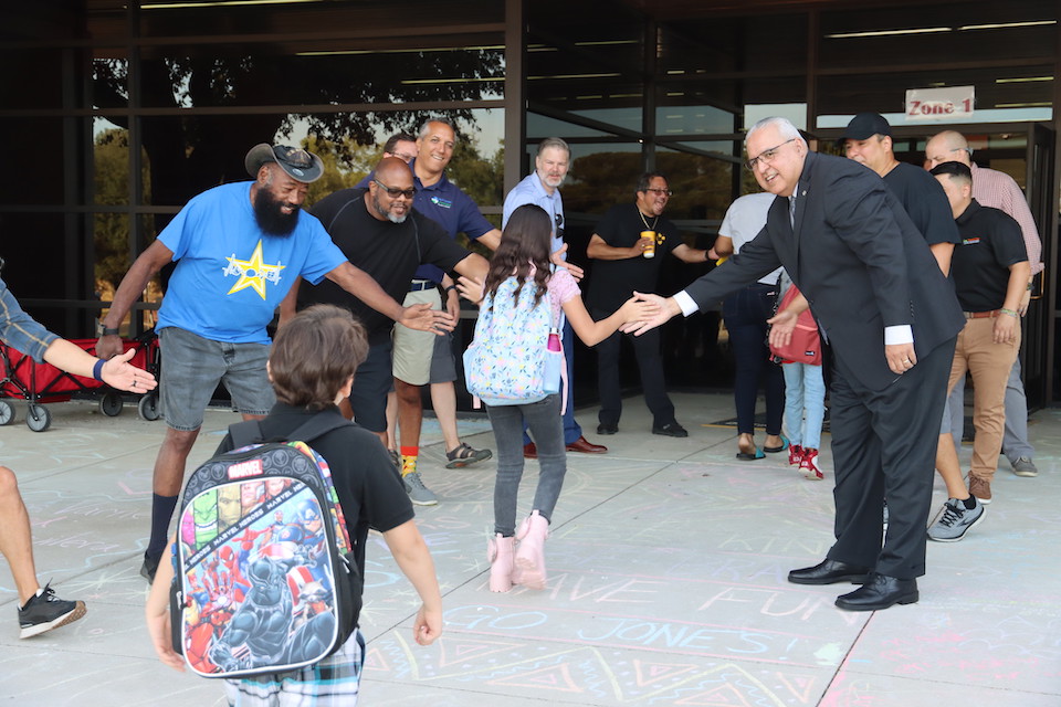 Super first day - Dr. Marcelo Cavazos tours the district and joins Jones dads as they clap in the students