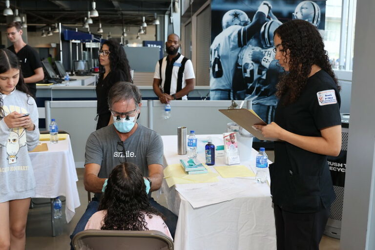 Bowie P-TECH students help at the Back to School Kickoff dental clinic