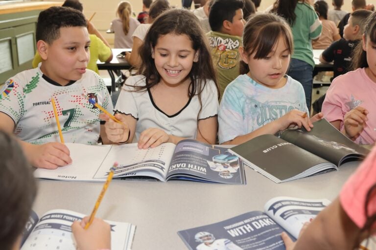 Dallas Cowboys and Blockchain.com donate math books to third graders