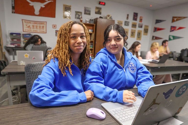 Two Arlington College and Career High School students working together