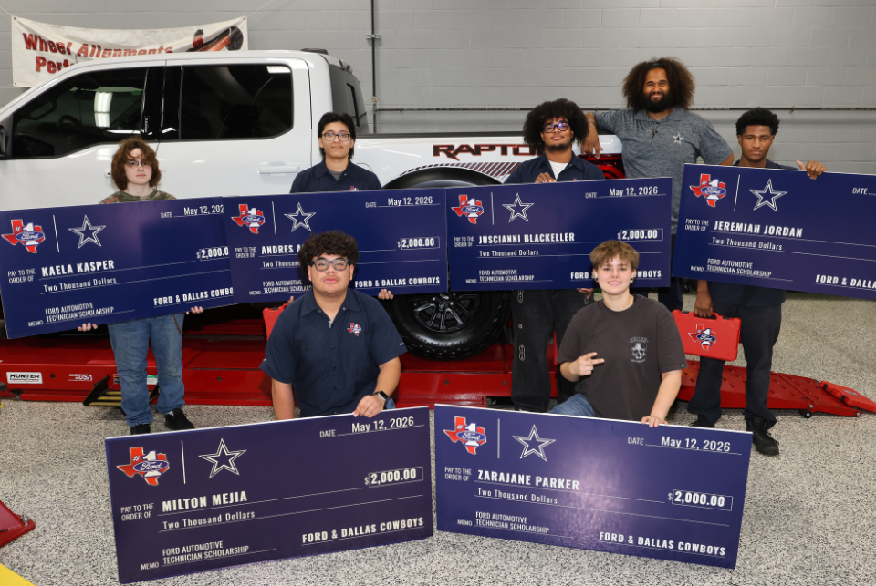A group of people stand proudly, each holding a large check for $2,000. They are in front of a Ford vehicle inside a garage. The checks are awarded by Ford and the Dallas Cowboys. Names on the checks include Kaelan Kasper, Milton Mejia, Andres P., Josquaine Blackeller, Zarajaine Parker, and Jeremiah Jordan.