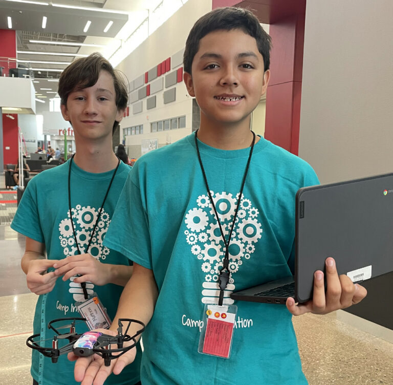 Two students with a drone and a Chromebook