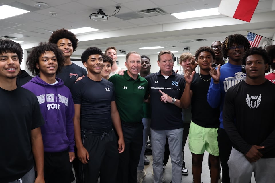 Renegades coach Bob Stoops and QB Luis Perez visit Arlington High football team