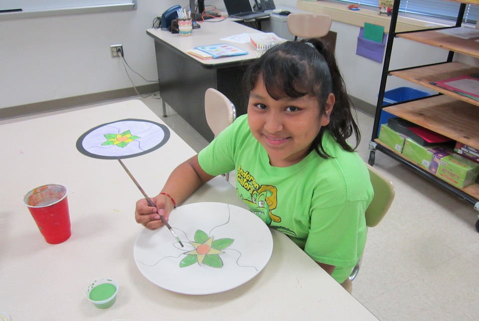 Student paints ceramic plate for Arlington ISD Dream Makers Awards banquet