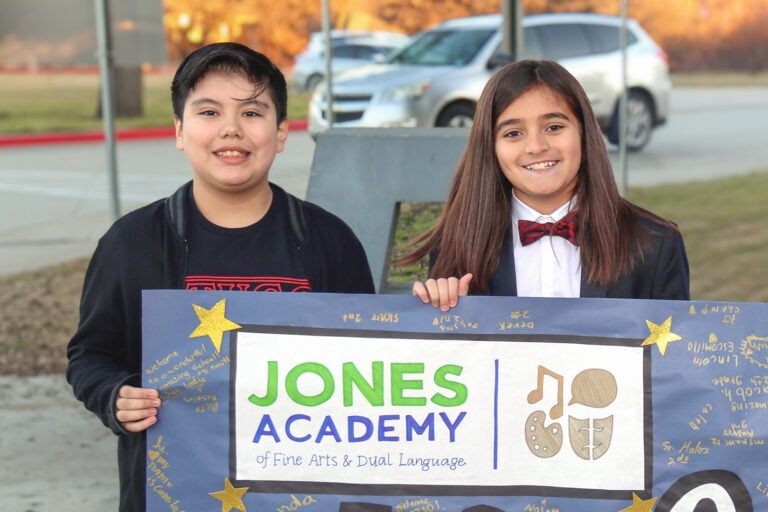 Students holding a Jones Academy Banner