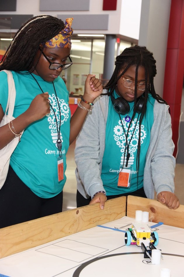 Two students with a Spike Prime robot