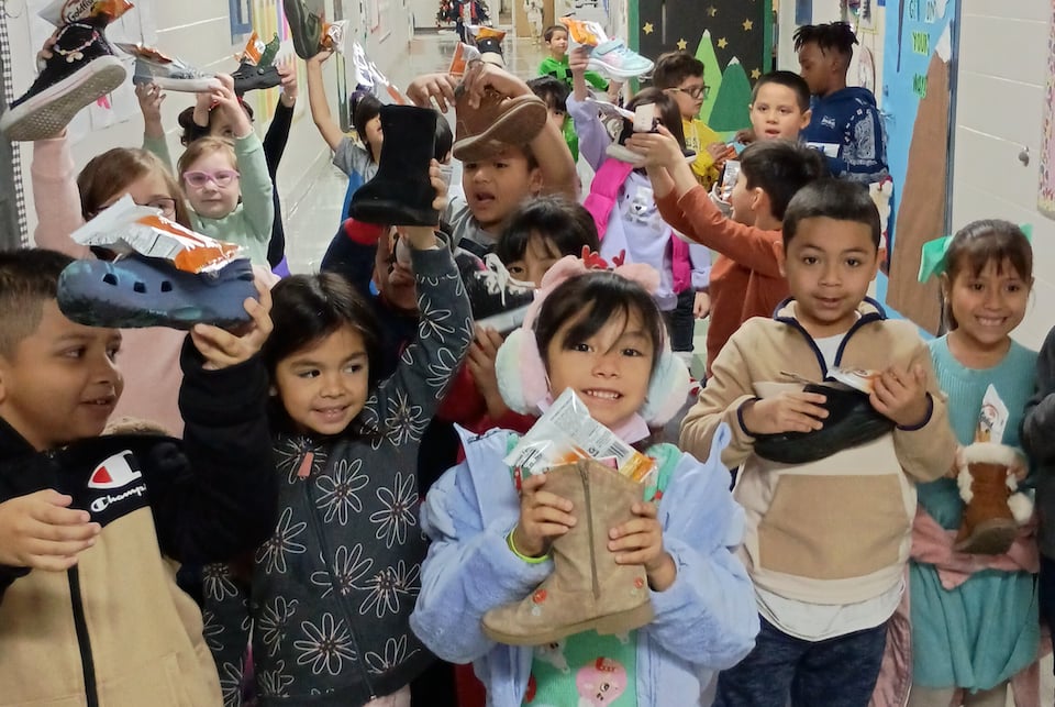 St. Nick drops gifts in students' shoes at Wimbish World Language Academy
