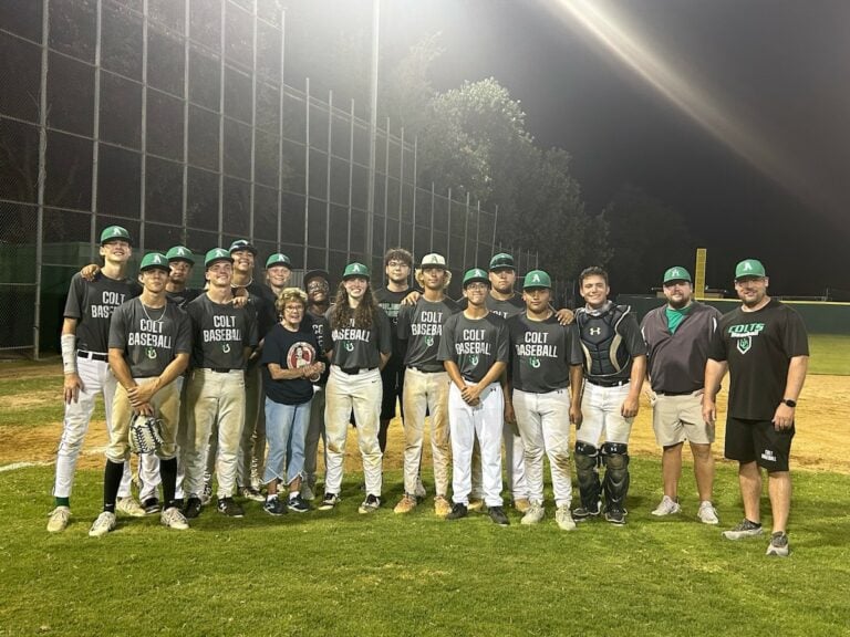 Gloria McCloskey Rogers visits with the Arlington High baseball team